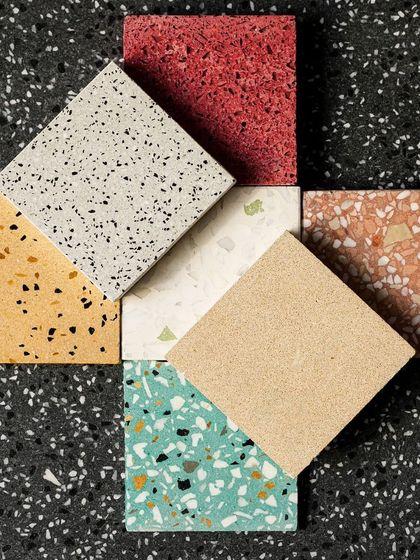 A creative composition of seven different terrazzo tiles, demonstrating the endless possibilities for custom color and pattern combinations.