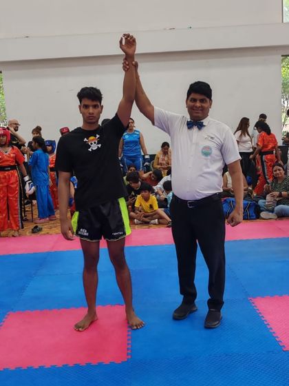 Victory declared. A StrikeHive student is announced the winner at the WAKO India Kickboxing Federation district championship.