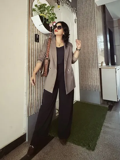 A perfect example of modern power dressing. This look combines a structured blazer with elegant wide-legged pants, creating a silhouette that is both authoritative and chic for the corporate environment.