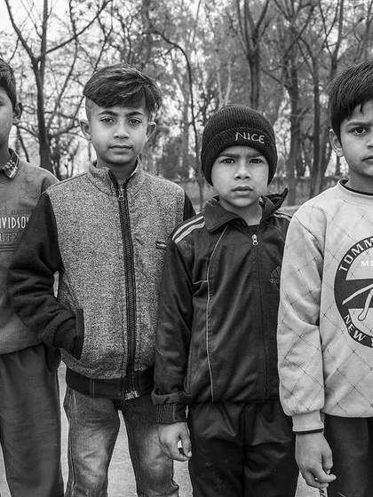 I asked this group of boys to stand for a photo. Even in a posed shot, their individual personalities shine through. Black and white helps unify the image and highlight their expressions.
