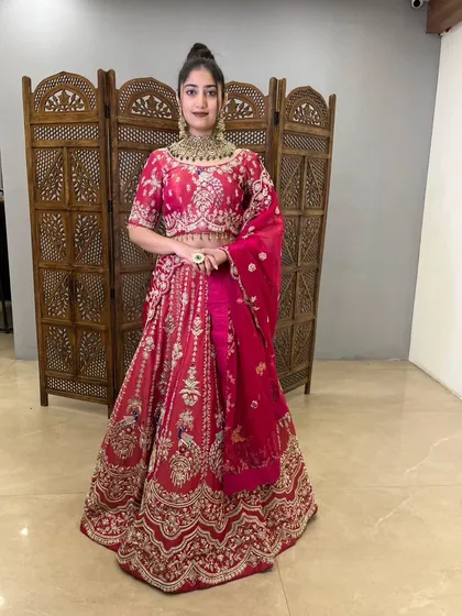 A classic pose in this beautiful pink lehenga, ready for a wedding celebration.