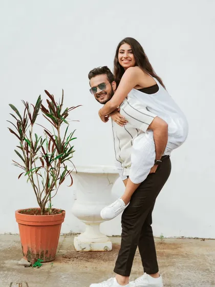 A playful piggyback ride captures the fun-loving spirit of this couple during their Goa pre-wedding shoot. We encourage couples to be themselves, resulting in natural and joyful photos.
