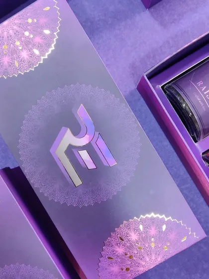 An example of our premium custom packaging capabilities. This purple gift box for a corporate client features their logo in a stunning holographic foil finish, complemented by intricate silver mandala patterns for a truly luxurious feel.