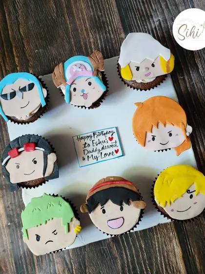 I was so excited to make this One Piece anime set. Each cupcake features a different character from the Straw Hat crew, like Luffy and Zoro, all hand-crafted from fondant.