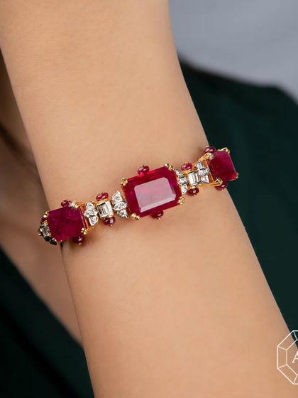 This stunning ruby and diamond bangle adds a touch of elegance to any look, whether dressed up or casual.