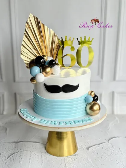 Cheers to 60 royal years. A majestic cake for a father's 60th, complete with a crown, a moustache, and stylish blue and gold details.