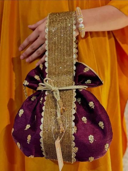 For a more regal look, I selected this deep purple potli with gold butti embroidery and a wide, heavily beaded handle.