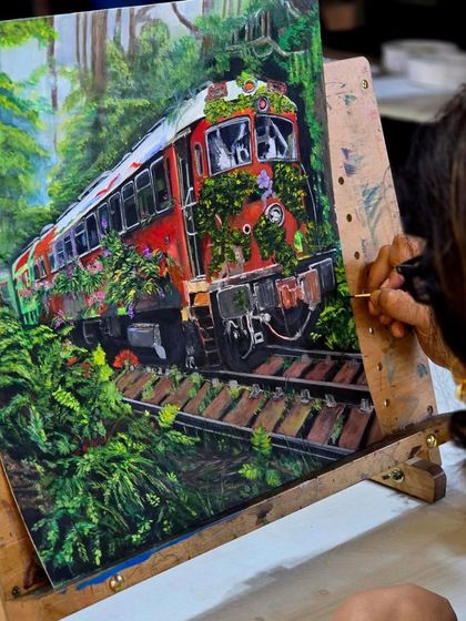 The full view of the gouache painting on an easel, showing the rich, opaque colors and complex composition.