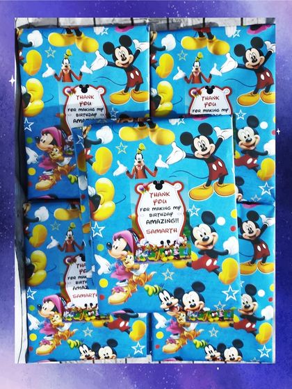 For a different party, I wrapped the space folders in Mickey Mouse themed paper with a personalized thank you sticker.