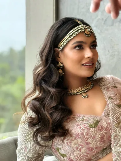 A close up shot of the soft waves and matha patti. This shows how a simple open hairstyle can be elevated with the right hair accessory.
