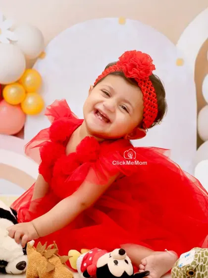 This is the kind of pure, unfiltered joy I aim to capture in every session. This little one's radiant smile in her vibrant red dress is a perfect memory of her milestone celebration.