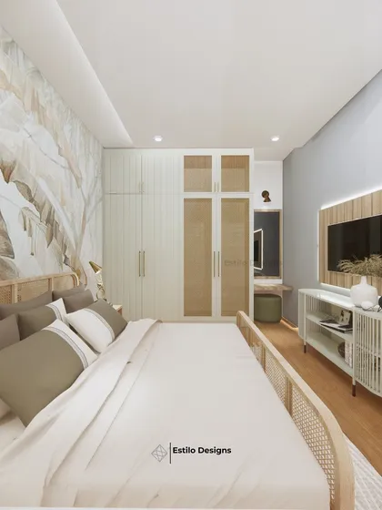 This bedroom design is inspired by tropical tranquility, using a cool grey and beige color scheme. I incorporated a large leaf-patterned wallpaper and cane furniture to bring a natural, calming element into the room.