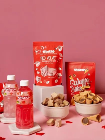 A Valentine's Day product lineup for a snack brand, featuring red and pink packaging. I use color-coordinated backgrounds and props to create a strong thematic look for campaign visuals.