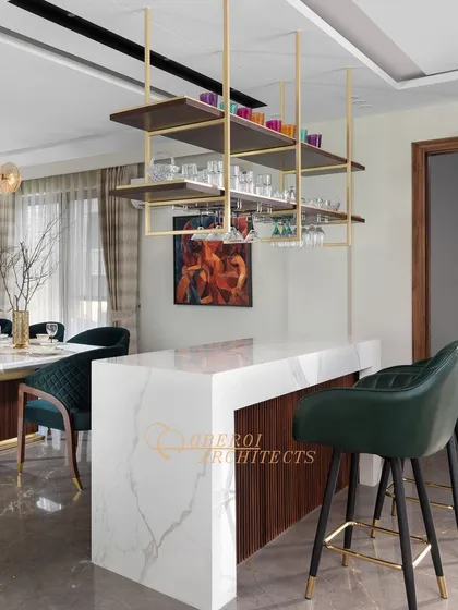 A closer view of the custom bar, highlighting the elegant marble countertop and comfortable leather-finished bar stools.