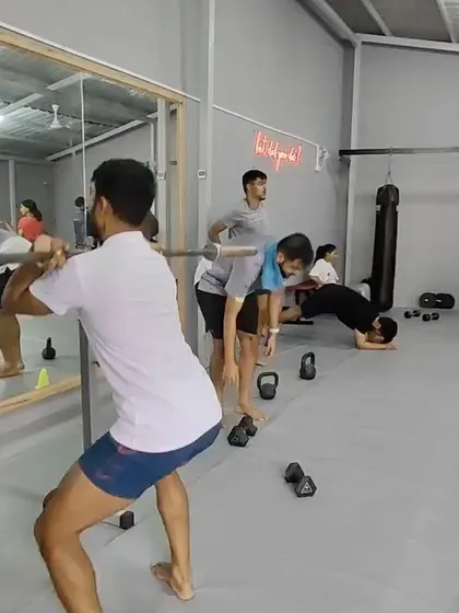 Members working on barbell good mornings and other strength exercises during a packed Sunday class.