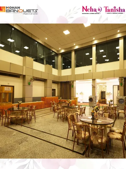 Even the dining areas at Mohan Banquets are crafted for elegance. This image shows a section of the hall set up with round tables for a comfortable dining experience during a corporate event or reception.