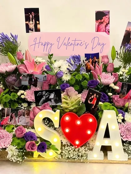 I believe in making grand romantic gestures unforgettable. This bespoke Valentine's Day arrangement was created with a garden of fresh flowers, personalized photos, and light-up initials to celebrate a unique love story.