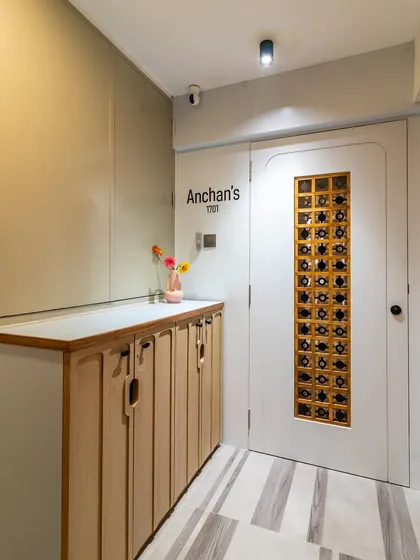 This wider shot shows the complete entryway, with the custom door, personalized nameplate, and functional storage creating a cohesive and inviting first look.