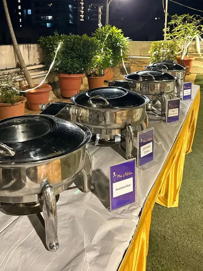 The main course section of a terrace party buffet, with all dishes kept hot in chafing dishes.