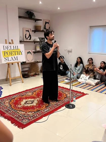 A performer captivates the audience at our studio. The floor seating and close-knit arrangement create a warm and personal atmosphere for everyone.