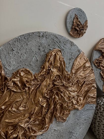 An angled view of the gold and grey textured set, highlighting the 3D quality of the sculpted fabric.