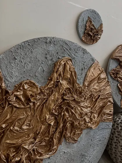 An angled view of the gold and grey textured set, highlighting the 3D quality of the sculpted fabric.
