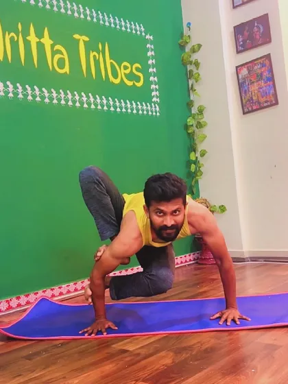 Finding stability in a twisted arm balance. This variation of Grasshopper Pose requires deep core engagement and open hips to lift off the ground.