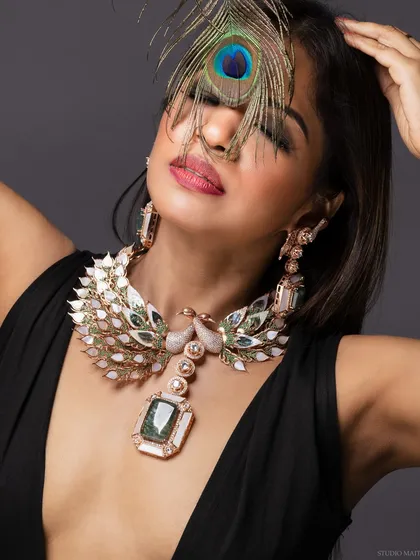 A detailed glamour shot focusing on a statement peacock-themed jewellery piece. I work closely with jewellery designers to create images that make their pieces shine.