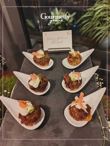 Gochujang Mushrooms with Yuzu, served on individual white spoons. This appetizer showcases our flair for creating unique Asian-inspired bites.