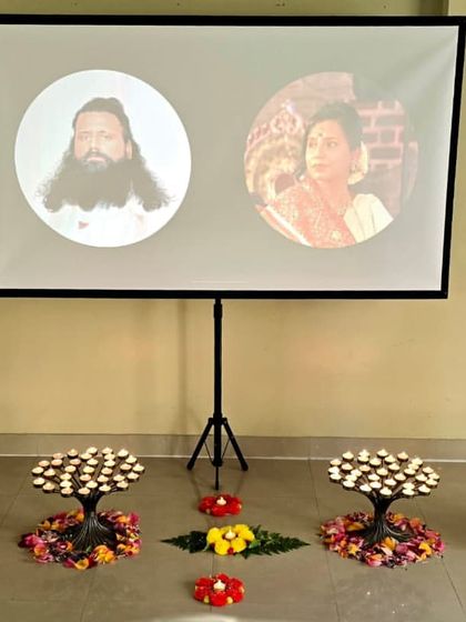 A setup for our Chakra Meditation Program, with portraits of us and candles arranged to represent the chakras. This shows the thoughtful preparation and sacred atmosphere we create for our healing sessions.