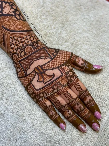A close-up of the floral bridal design on the palm.