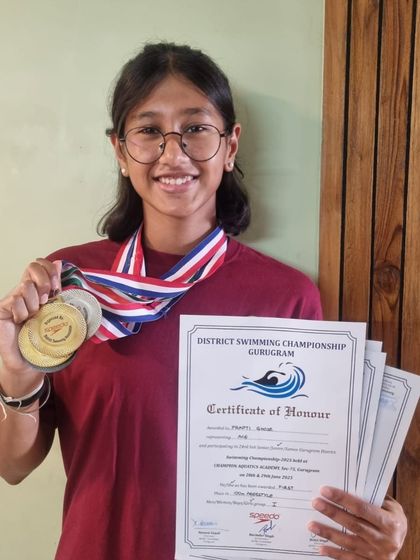 Prapti Ghose with her 4 gold medals and certificates from the Gurugram district championship, where she also achieved new personal best times.