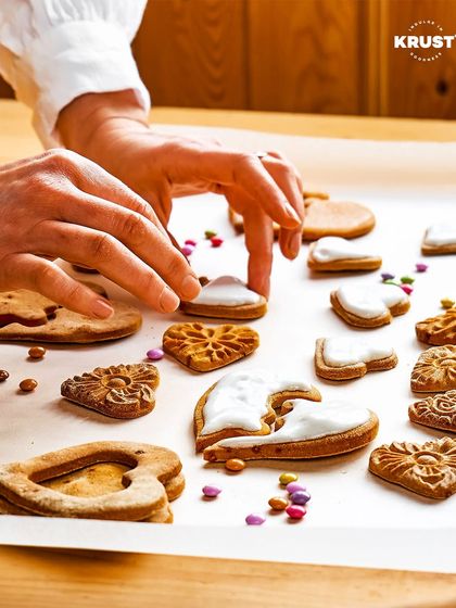 A participant carefully adding icing to heart-shaped cookies. This shot captures the delicate, hands-on nature of our cookie decorating sessions.