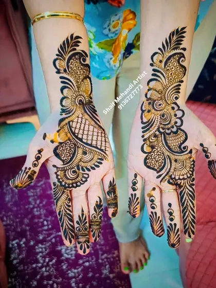 A striking Arabic design with a mix of net patterns and bold, dark peacock-like swirls.