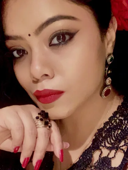 A dramatic close-up for a pre-Diwali look, featuring bold winged eyeliner, a red lip, and statement earrings.