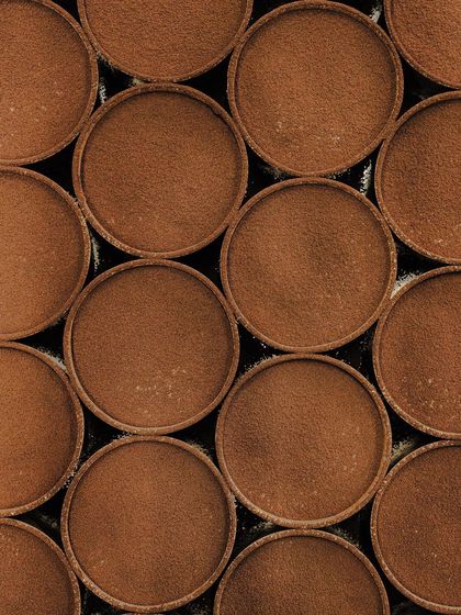 A top-down view of our classic tiramisu desserts, beautifully dusted with cocoa powder and ready to be served.