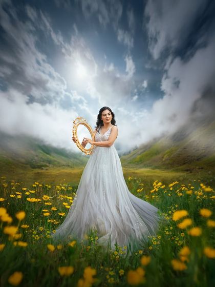 A powerful and imaginative portrait where the mother to be holds a mirror to the sky. This photo blends reality and fantasy for a truly unique maternity picture.