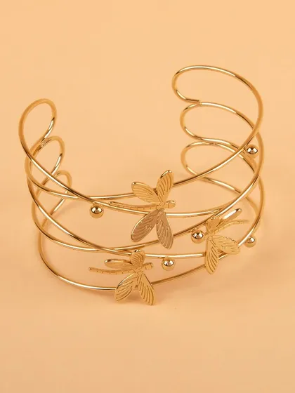 A delicate, multi-layered gold-tone cuff bracelet adorned with small dragonflies.