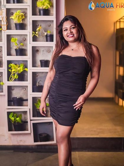 A confident pose in a classic black dress.