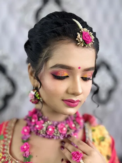 A soft, candid shot of the Haldi makeup, highlighting the glowing skin and colorful eyeshadow.