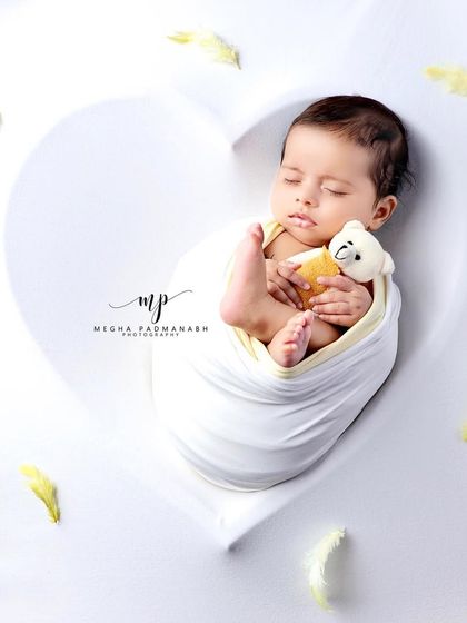 A full view of the heart-shaped setup, showing the scattered yellow feathers.