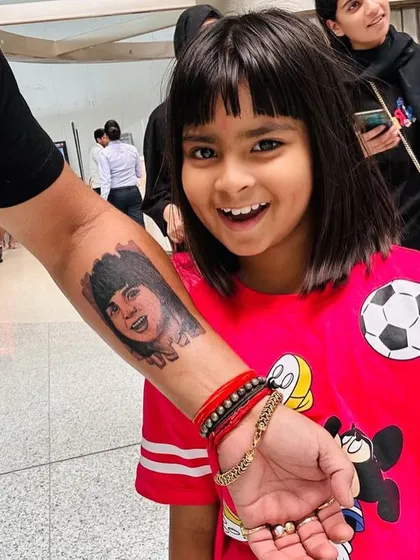 There is nothing more special than capturing a loved one in a permanent portrait. We worked closely with this client to create a realistic tattoo of his daughter, focusing on her joyful expression. Seeing the finished tattoo next to her photo shows the level of detail and likeness we strive for in our portrait work.