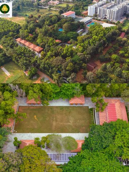 An aerial overview of the Gold Coins Club & Resort, showing the property's layout, cottages, and recreational areas surrounded by dense trees.