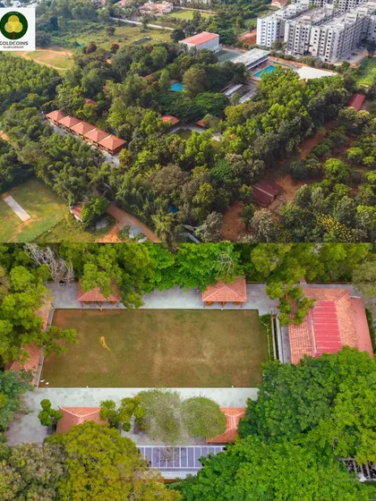 An aerial overview of the Gold Coins Club & Resort, showing the property's layout, cottages, and recreational areas surrounded by dense trees.