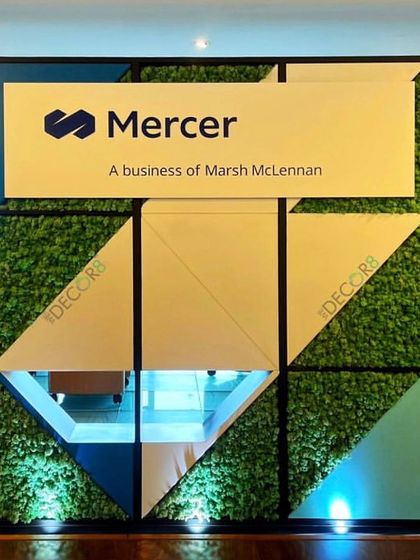 For the Mercer office, we designed and installed this geometric moss wall that incorporates their branding. This piece is completely maintenance-free and acts as a powerful, green statement piece in their reception area, lit from below to highlight its texture.