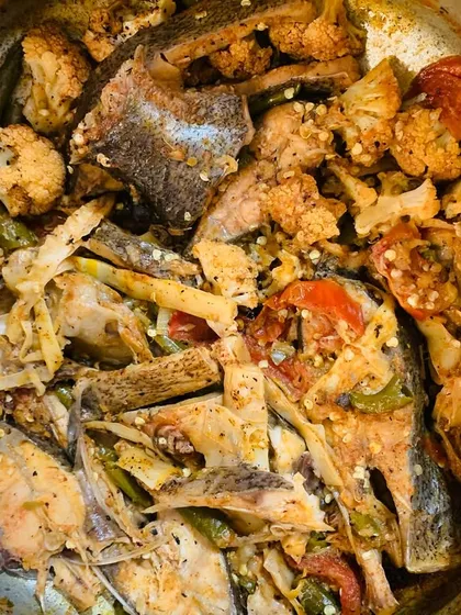 A mix of fish, cauliflower, and bamboo shoot cooked together.