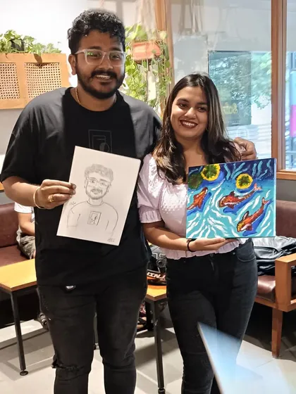 Here's another shot of the happy couple from the Third Wave Coffee event. The guy is holding my caricature, and his partner is showing off her own painting. It was a day full of art.