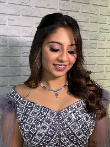A beautiful engagement look featuring soft smokey eyes and a mauve-pink lip. The makeup was designed to complement her intricate lavender-grey lehenga.