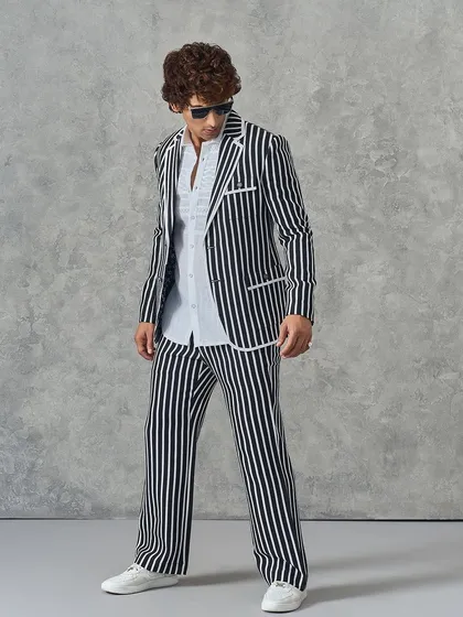 A full-length shot of our black and white striped suit, a bold and classic choice for the modern man.