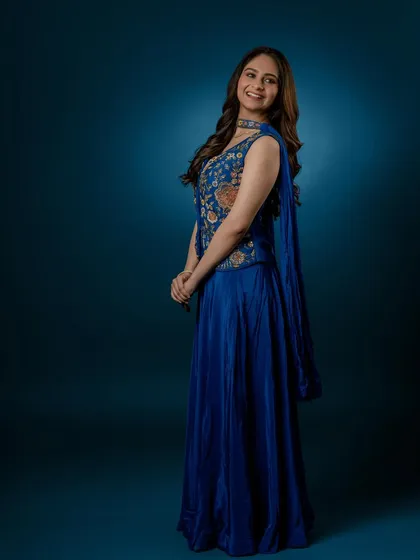 A happy, smiling shot that shows the versatility of the outfit, perfect for both formal and celebratory occasions.